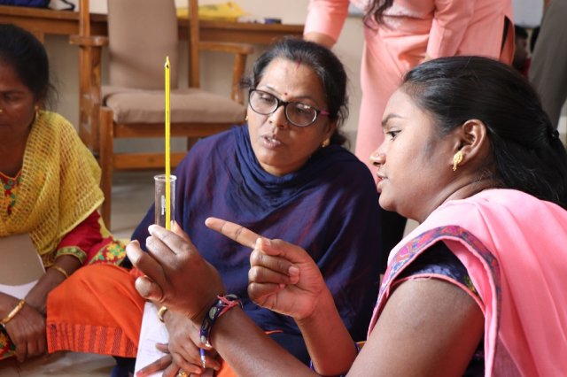 Two Teachers discussing about the practical. 