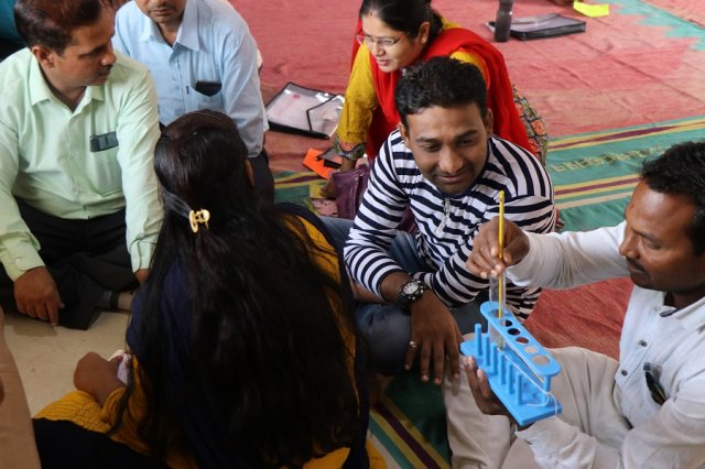 Resource person Rajendra clearing doubts of a teacher.