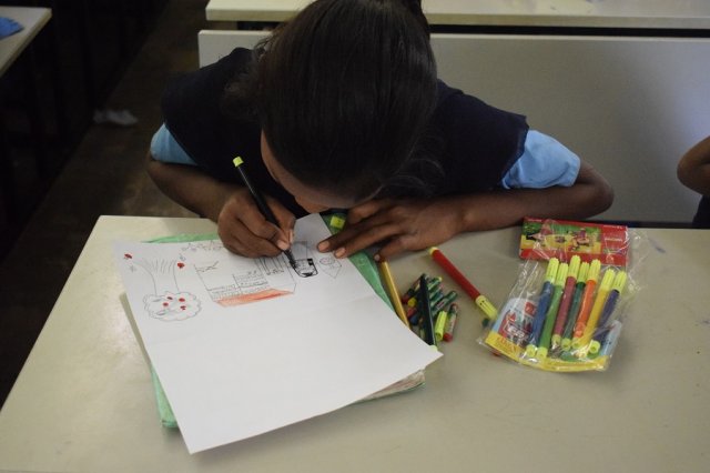 Dharmini, completely engrossed in drawing.